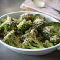 Cooked broccoli in a white oval dish