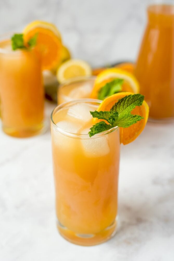 Fresh mint and citrus slices garnish a glass of lemonade