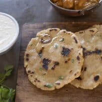 Naan bread pieces served with raita