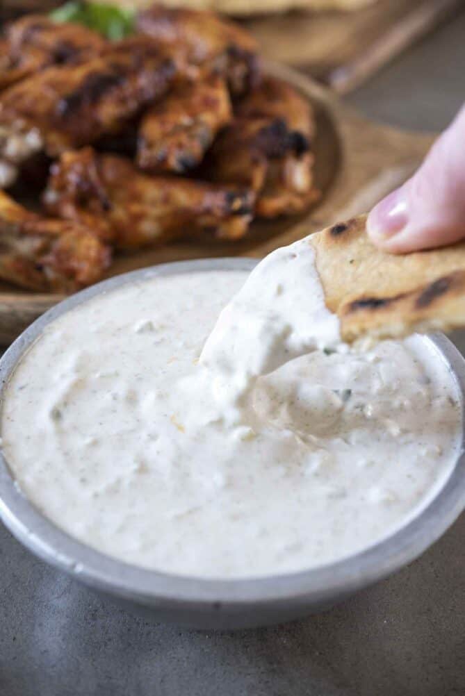 Dipping naan bread into raita