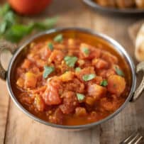 Indian tomato chutney in a bowl garnished with cilantro