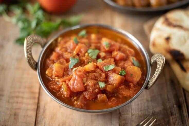 Indian tomato chutney in a bowl garnished with cilantro