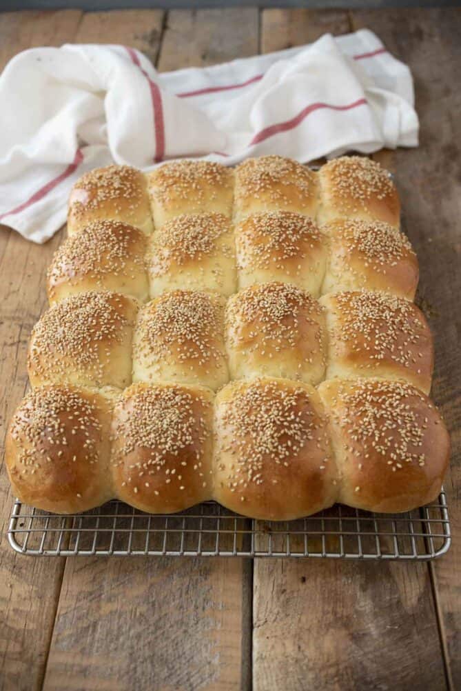 Fresh bread rolls fresh from the oven cooling on a wire rack