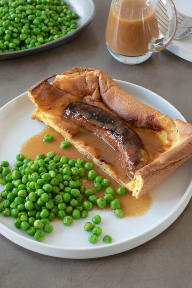 Yorkshire pudding/popover batter cooked with a sausage