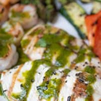 Perfectly grilled chicken breast drizzled with herb sauce
