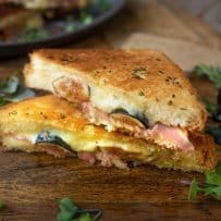 Cheese and fresh fig oozing out of a half of grilled cheese