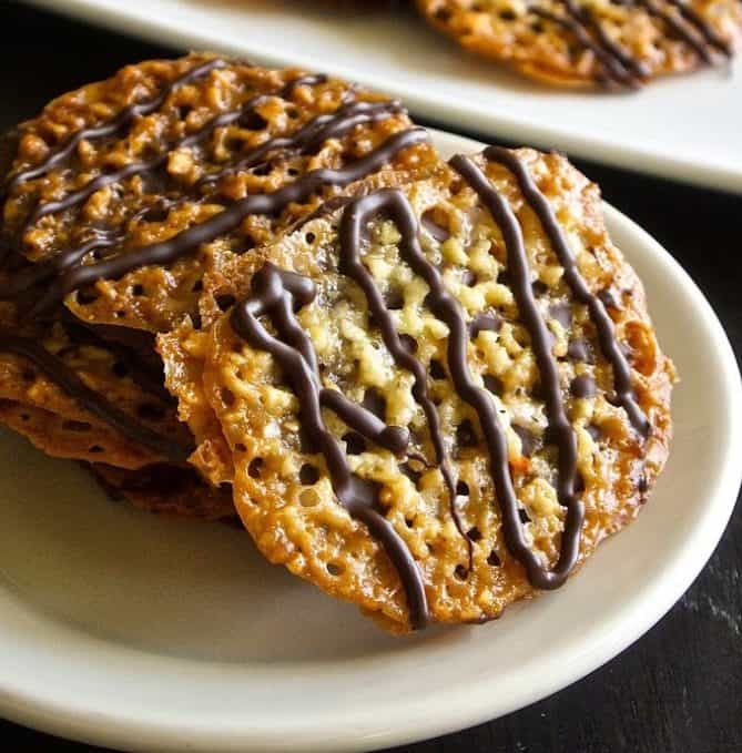 Florentine cookies are lace cookies made from chopped almonds with orange & vanilla. They are then sandwiched with chocolate and you get the most delicious cookies.
