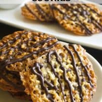 Dark chocolate drizzled onto Florentine cookies on a plate
