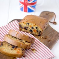 A tea cake cut showing the dried fruit inside