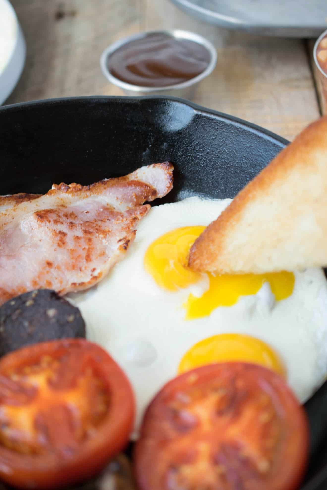 Dipping a piece of fried bread into an egg yolk