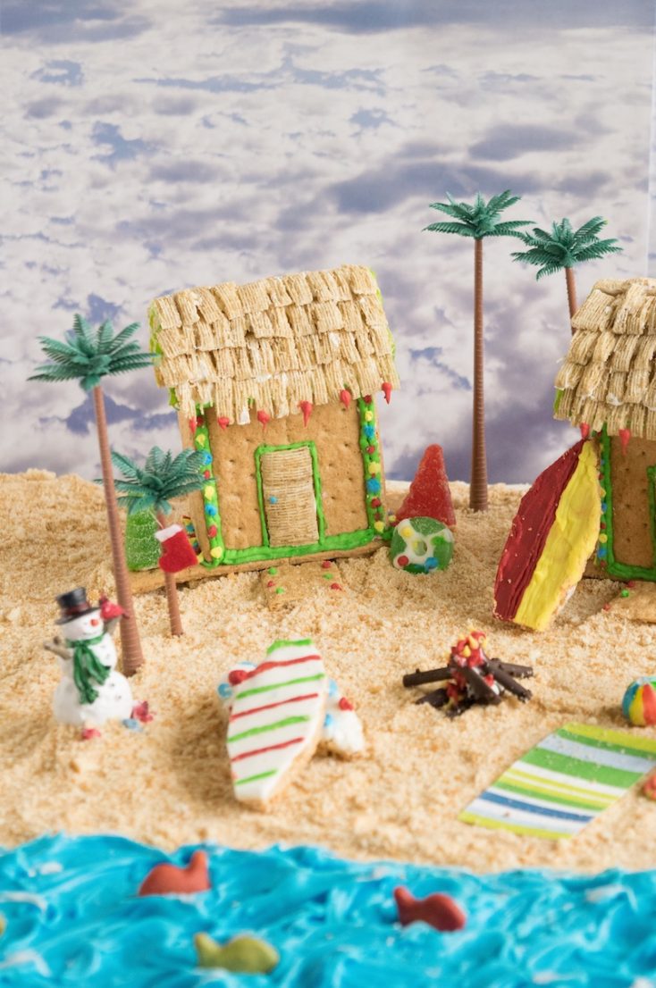 An edible beach scene made from graham crackers and frosting with cookie surfboards