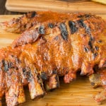 Grilled barbecue spare ribs on a board with corn