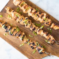 An overhead image of 3 skewers on a board