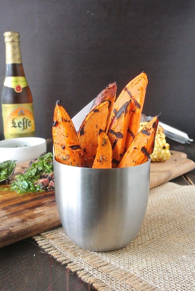 A silver container filled with grilled sweet potatoes