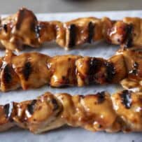 A closeup of charred and grilled chicken pieces