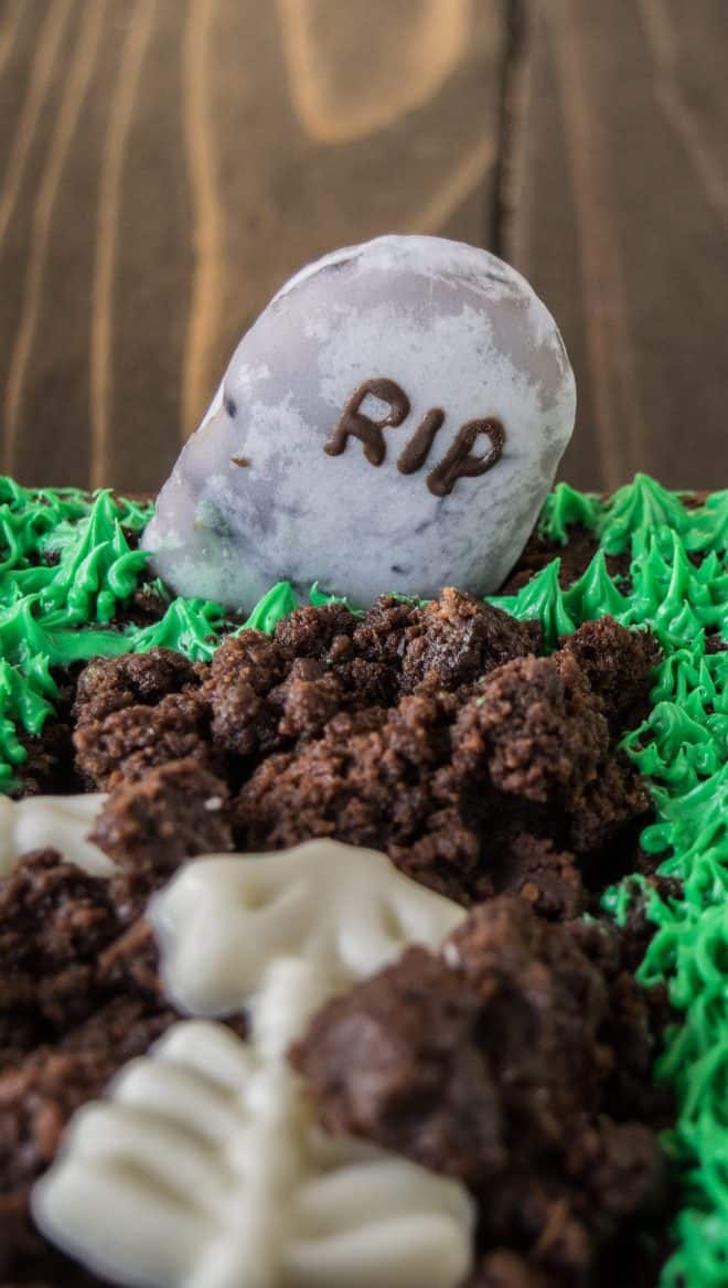 A closeup of the cookie headstone with RIP piped in chocolate