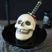 This Halloween skull and dagger cake is a fun and spooky centerpiece that will be sure to scare any Halloween partygoers. This cake can also serve as desserts for  your guests, if they dare to eat it.