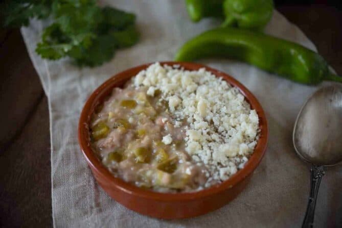 Refried beans mixed with hatch Chile peppers topped with crumbled cheese