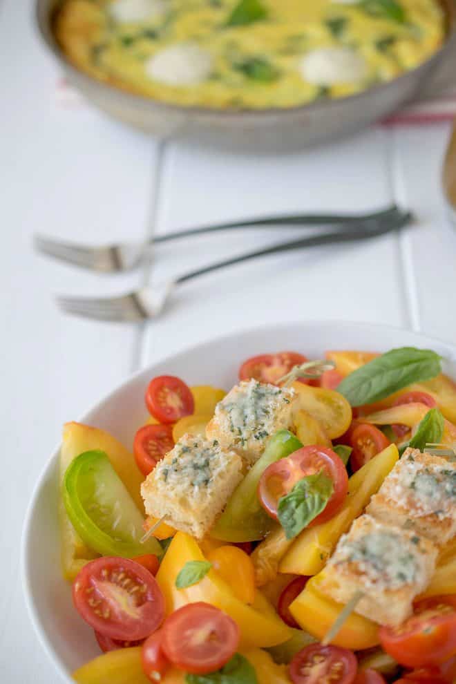 A closeup showing the croutons topped with melted Parmesan and basil