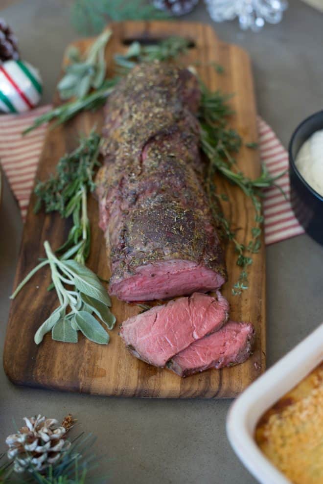 Perfectly roasted beef tenderloin garnished with fresh herbs