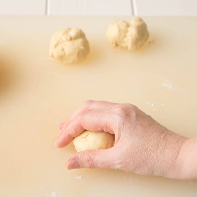 Rolling and shaping bread dough into rolls