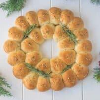An edible wreath made from bread rolls viewed from overhead