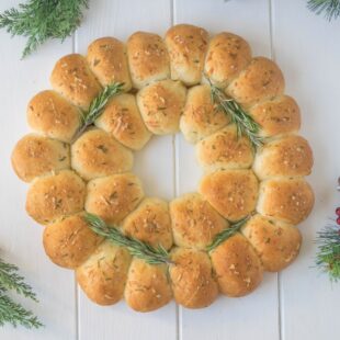 An edible wreath made from bread rolls viewed from overhead