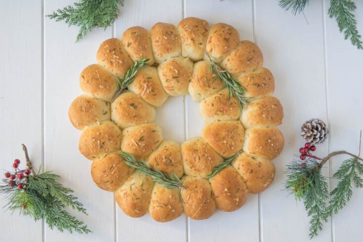 An edible wreath made from bread rolls viewed from overhead