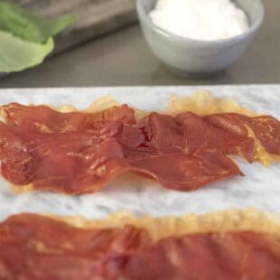 A closeup of a slice of prosciutto