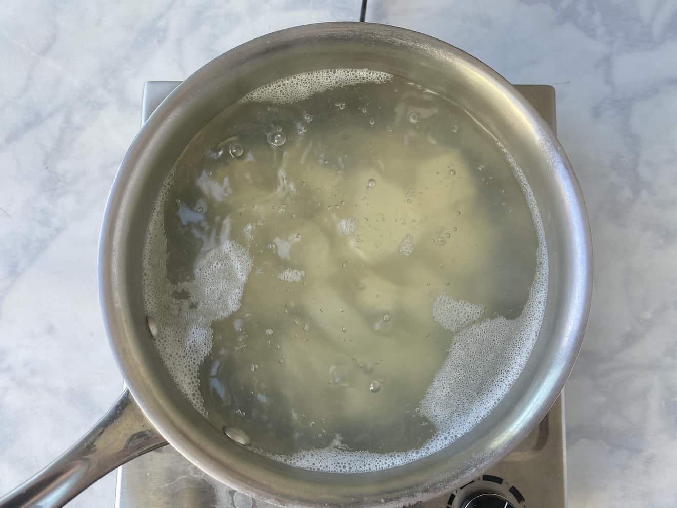 Boiling potatoes in a pan of water