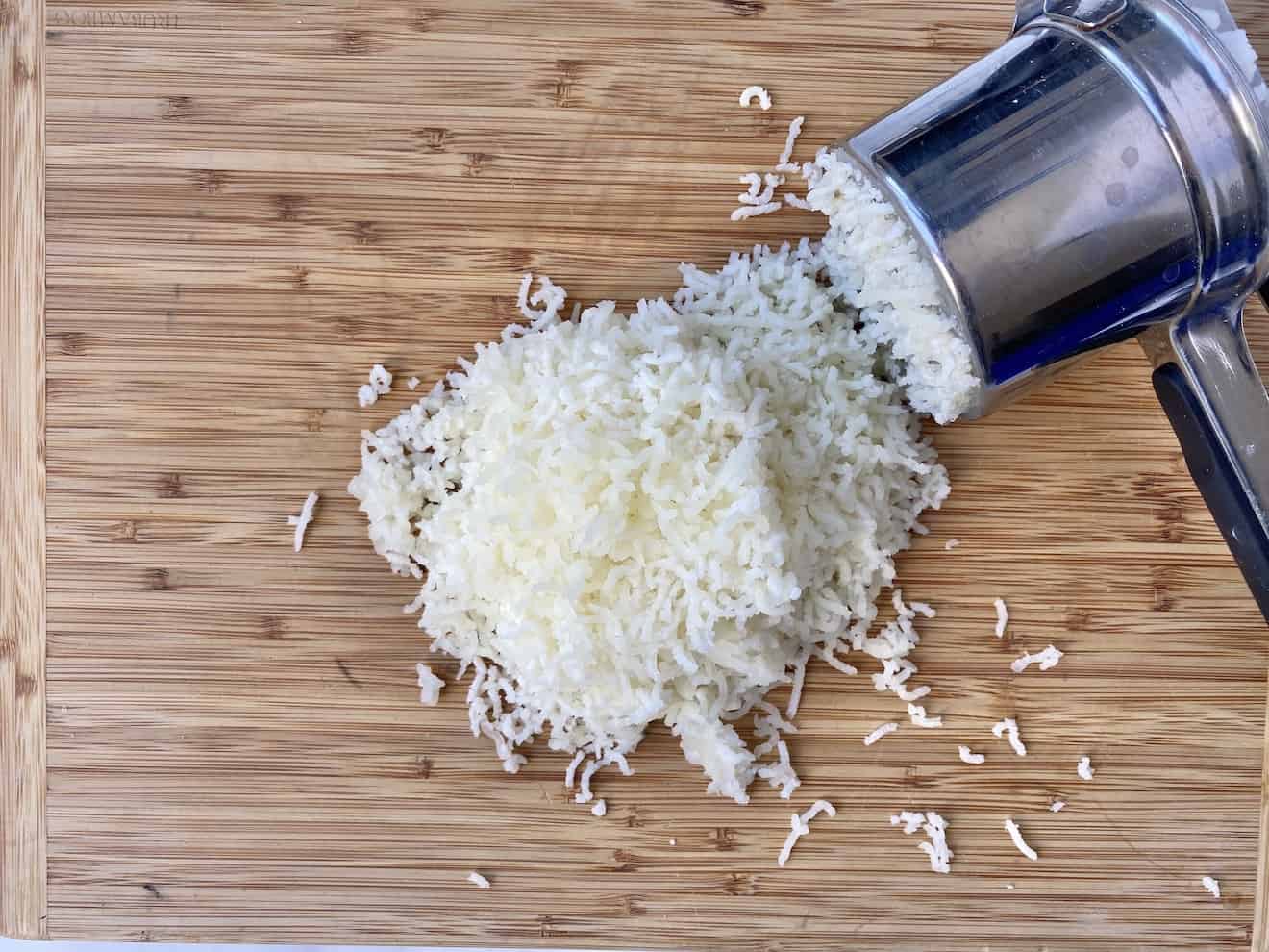 Potato being mashed by passing through a ricer