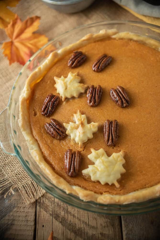 A maple sweet potato pie topped with glazed pecans