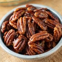 A closeup of pecan halves glazed with maple syrup