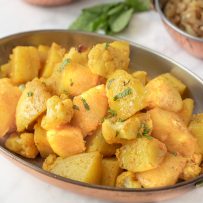 Potatoes and cauliflower seasoned with spices garnished with fresh mint