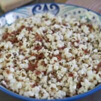 An Italian style decorative bowl filled with popcorn