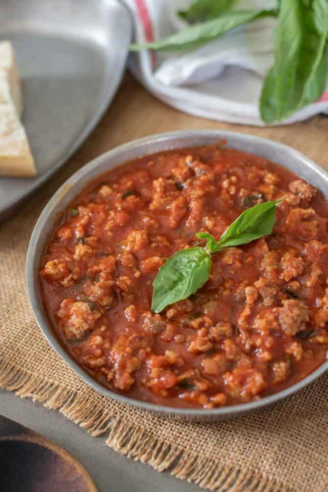 Italian Sausage Ragu di Salsiccia  in a pan with basil leaves