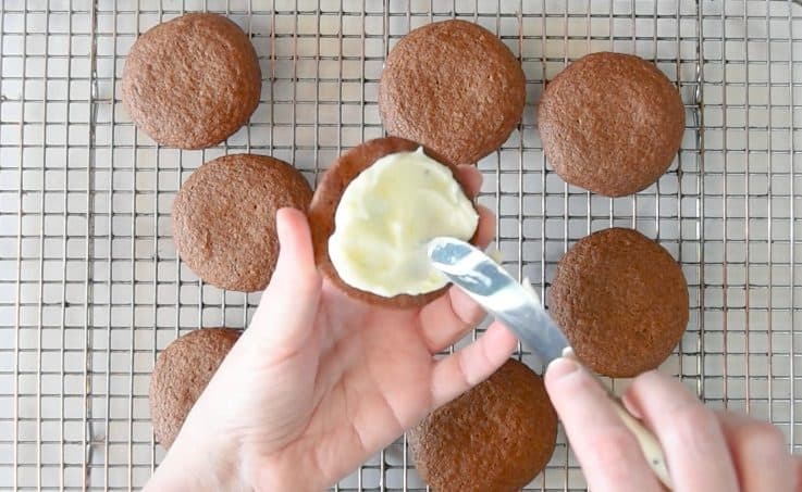 Lemon cream cheese filling is spread on 1 half of a sandwich cookie
