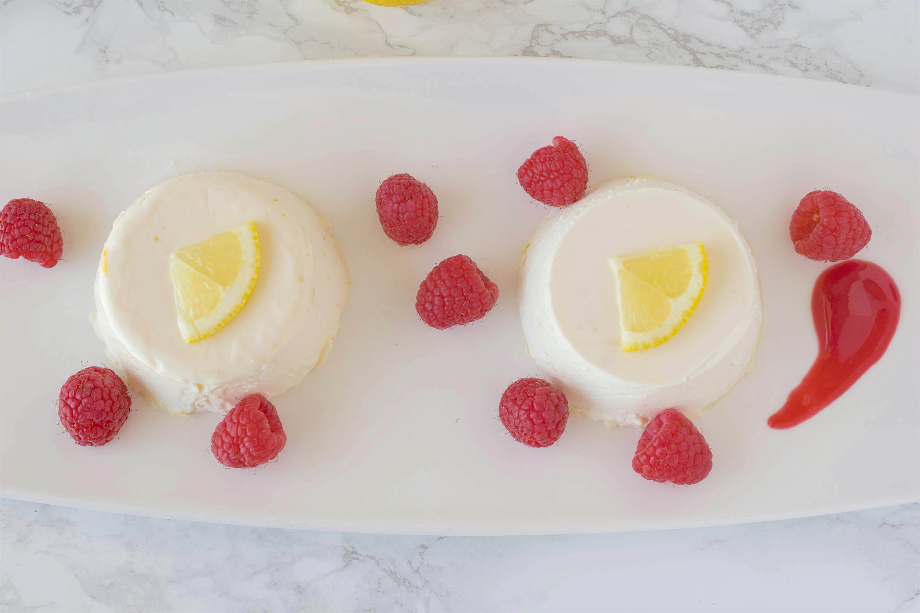 Lemon panna cotta with raspberry sauce. Creamy and sweet, this is an easy dessert that you make ahead, refrigerate then serve when you're ready for dessert.