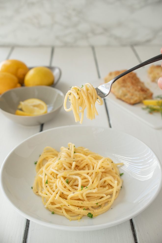 Lemon pepper spaghetti twirled around a fork