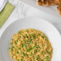 Green fresh peas sprinkled over lemon risotto