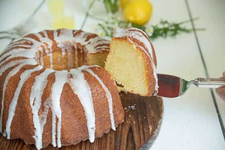 A slice of limoncello pound cake on a cake server showing the inside