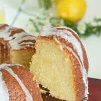A fluffy and yellow slice of limoncello cake on a cake slicer