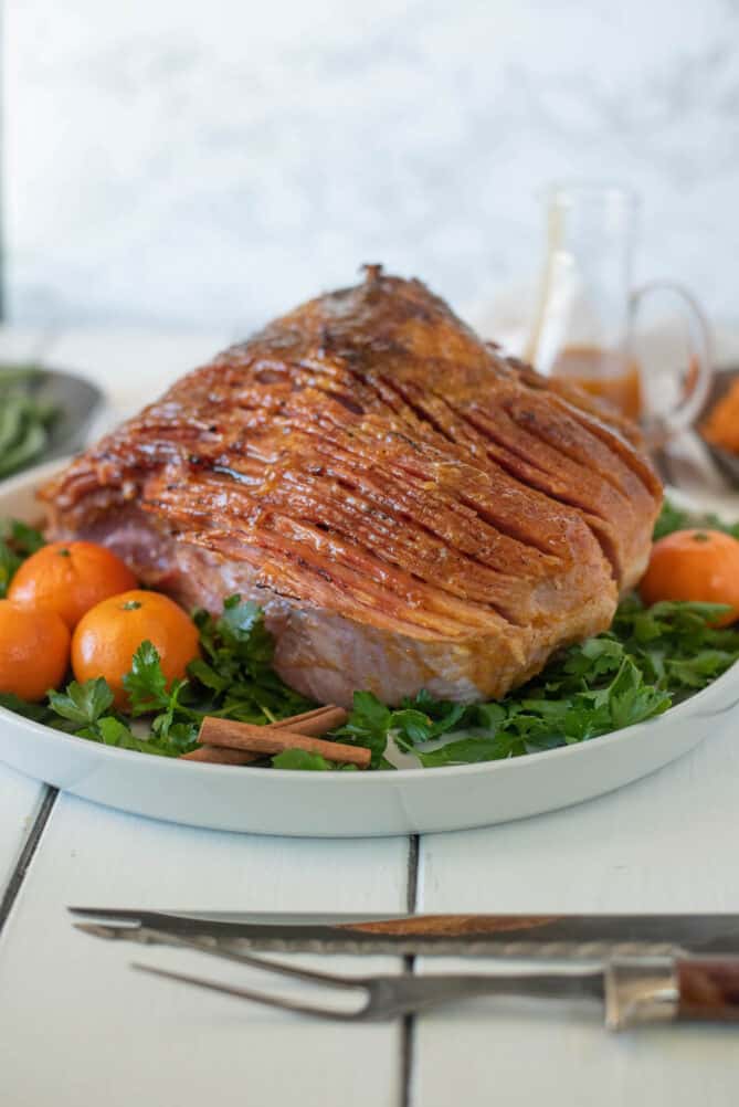 Mandarin orange spiced glazed ham ready to be sliced