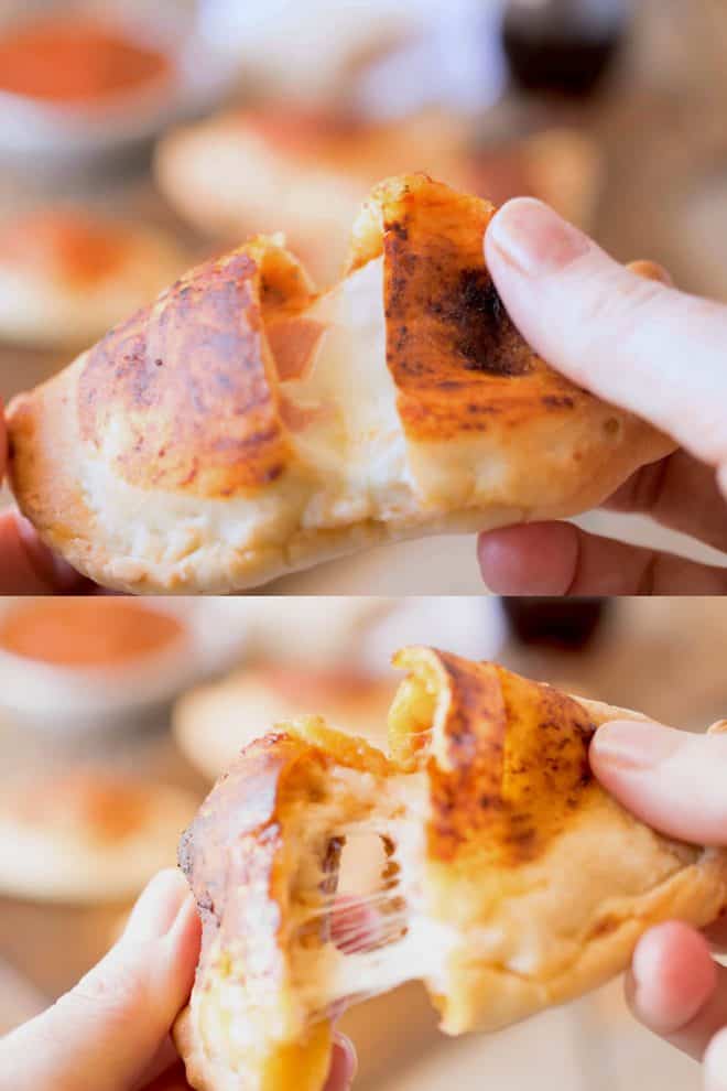 Pulling apart ham and cheese calzones showing the cheese and ham center