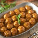 Mini meatballs in a curry coconut sauce garnished with fresh mint