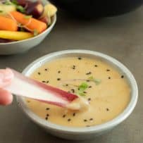 Dipping red Belgian endive into miso dip