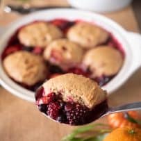 A ladle with a spoonful of berry cobbler