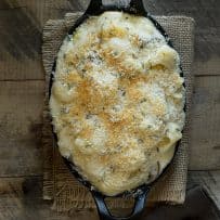 Mushroom sage mac and cheese baked in an oval cast iron skillet