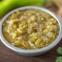 Chopped hatch green chiles in a sauce in a grey bowl