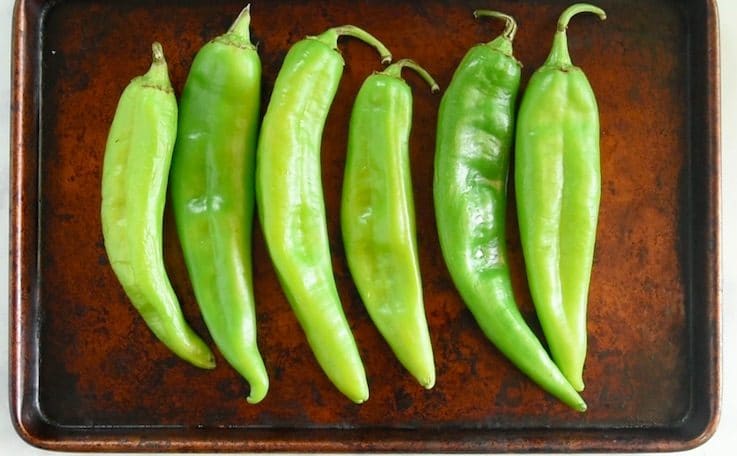 Fresh hatch green chiles on a baking sheet